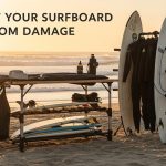 surfer storing surfboard safely in padded rack for surf equipment care