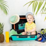 Organized baby travel kit with bottles, diapers, and clothes