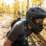 Cyclist wearing a mountain bike helmet riding a rocky Colorado trail.