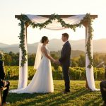 Bride and groom holding hands under a draped wooden arch during a romantic wedding ceremony.
