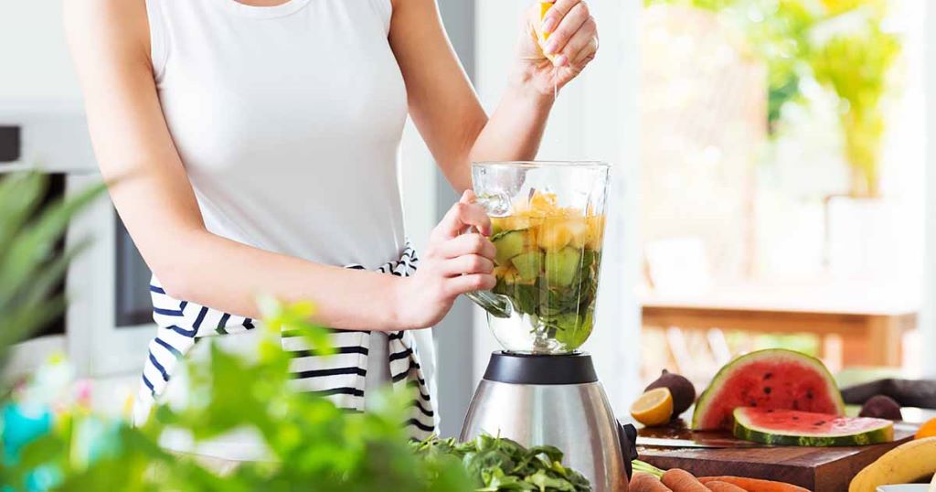High-performance blender making a creamy fruit smoothie with fresh ingredients on a kitchen counter in North Carolina