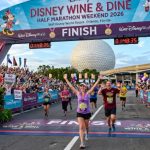 Runners crossing the finish line at the Disney Wine and Dine Half Marathon Weekend 2026 at Walt Disney World Resort in Orlando Florida with EPCOT in the background