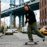 Skater wearing affordable skate pants performing an ollie on a NYC street