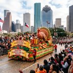 Downtown Houston street filled with spectators watching a Thanksgiving morning parade float