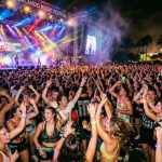Crowd dancing under stage lights at an Orlando music festival