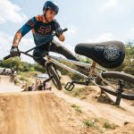 Male rider performing a BMX trick featuring a durable BMX seat.