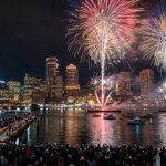 Fireworks lighting up Boston Harbor at midnight during First Night Boston New Year's Eve celebration