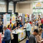 Crowds of book lovers browsing author tables at the Sunshine State Book Festival in Tallahassee, Florida