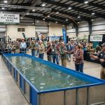 Anglers testing fly rods at a casting pool during a fly fishing expo in Athens, Georgia